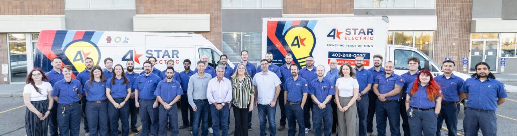 4 Star Team standing in front of two branded trucks.