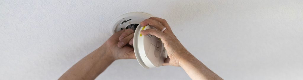 Close up of a hand holding a CO Detector