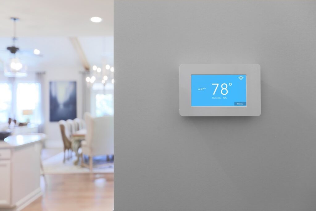 Smart thermostat on wall in energy efficient home