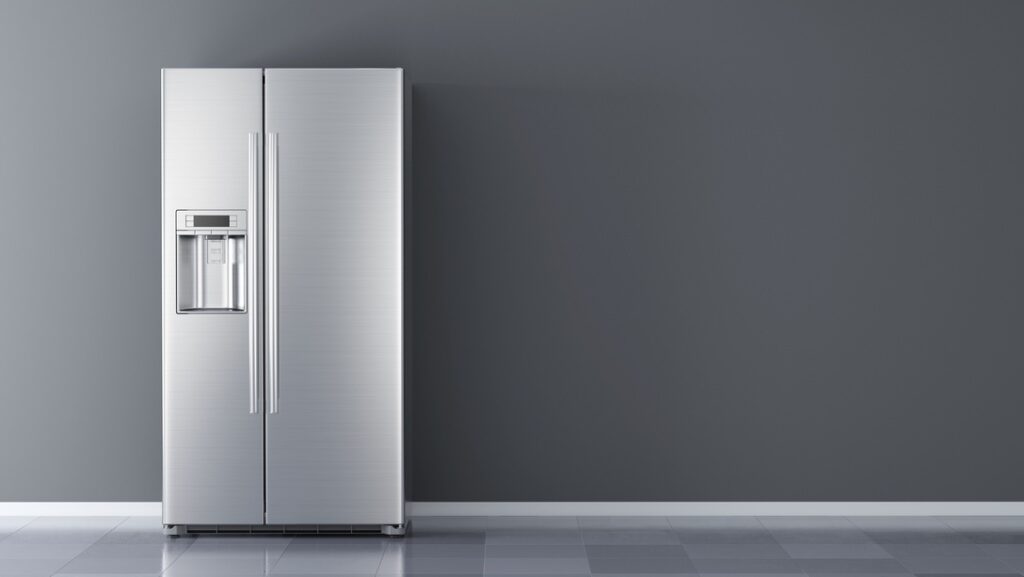 Silver refrigerator in an empty room