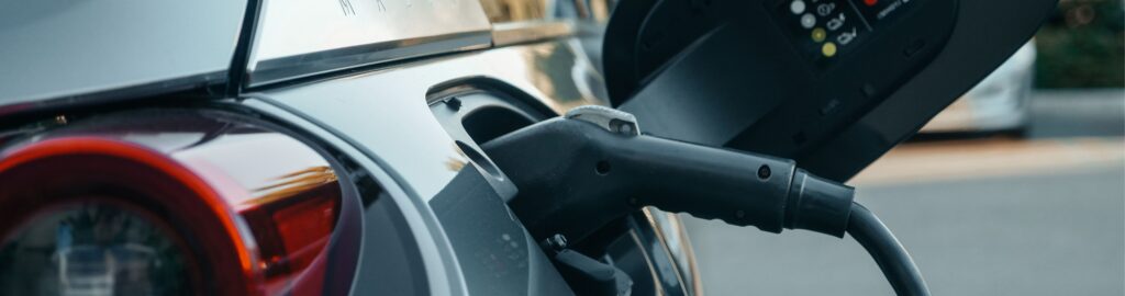 Close up shot of a car being charged by an EV charger