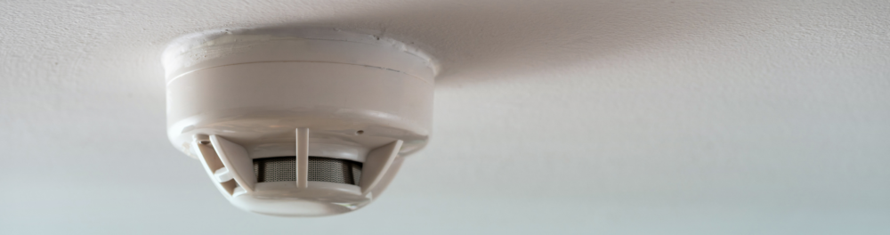 An image of a smoke detector installed properly on the ceiling of a home. Proper installation is key for functionality and proper readings.