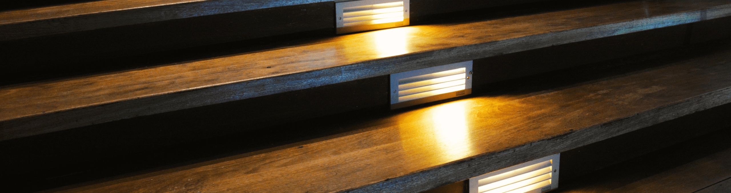 Newly installed lights on outdoor deck stairs help improve safety and functionality.