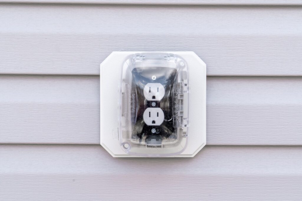 Electrical outlet with weather protector on outside of Calgary home