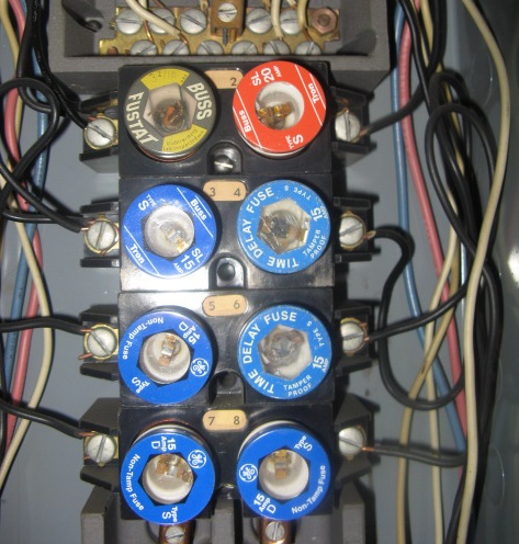 Close up of fuse panel with wires on the side
