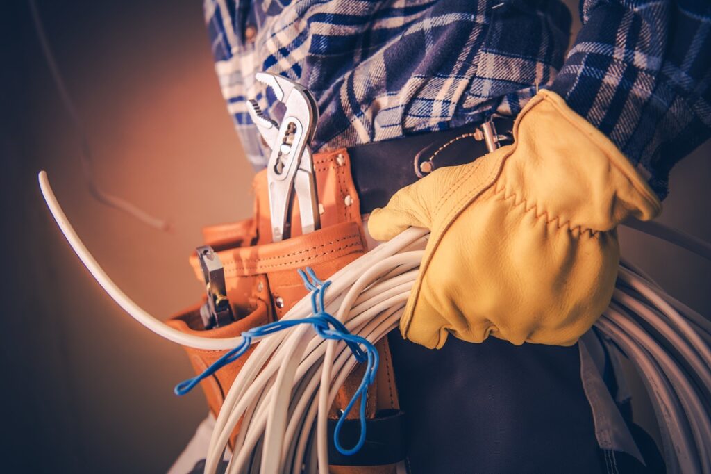 Electrician with Electric Cable Preparing For Installation in the Newly Constructed Building.