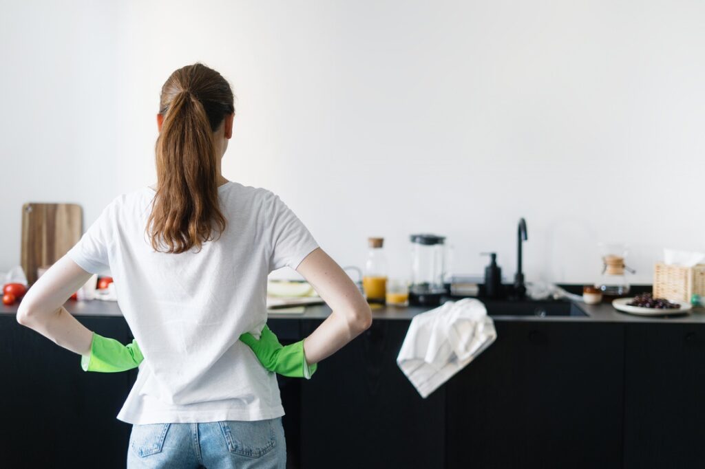 Homeowner looking at cluttered kitchen