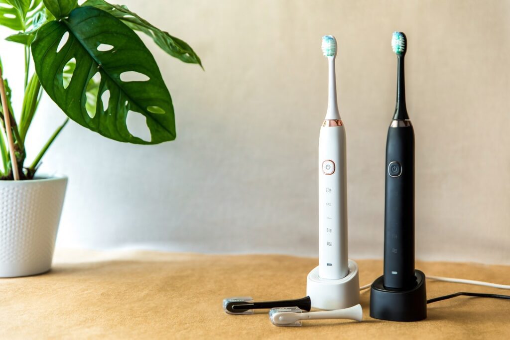 Electric toothbrushes placed next to each other on bathroom counter